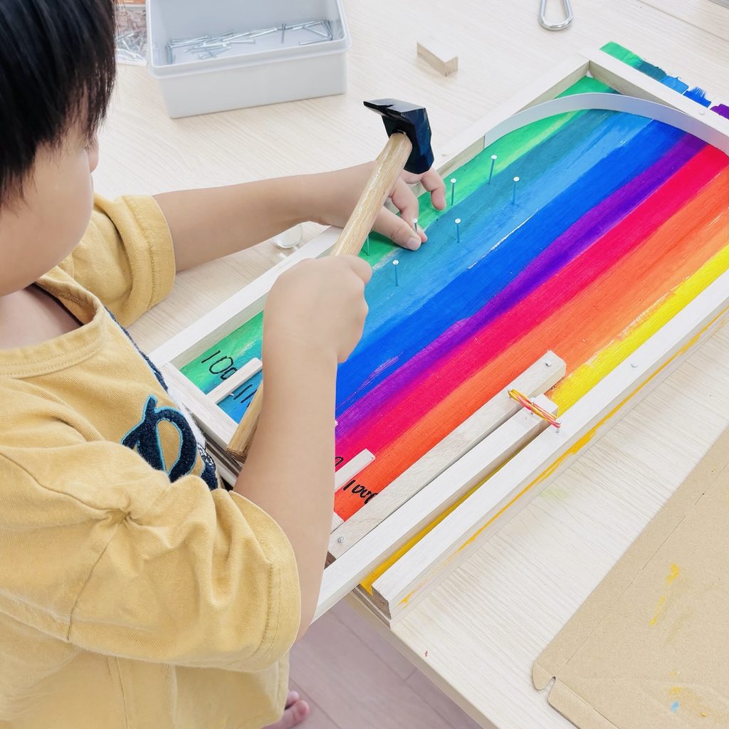 釘を打つ小学生の写真
